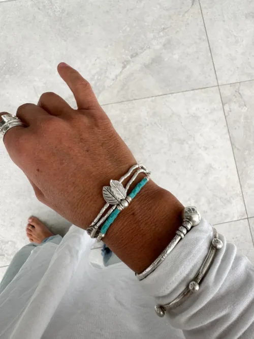 bohemian style silver jewellery. sterling silver wrap bracelet with 2 leaf charms - water safe for everyday wear. styled in bracelet stack