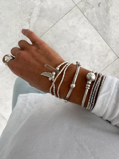 bohemian style silver jewellery. sterling silver wrap bracelet with crystal quartz and feather charm - water safe for everyday wear. 3 styles in 1