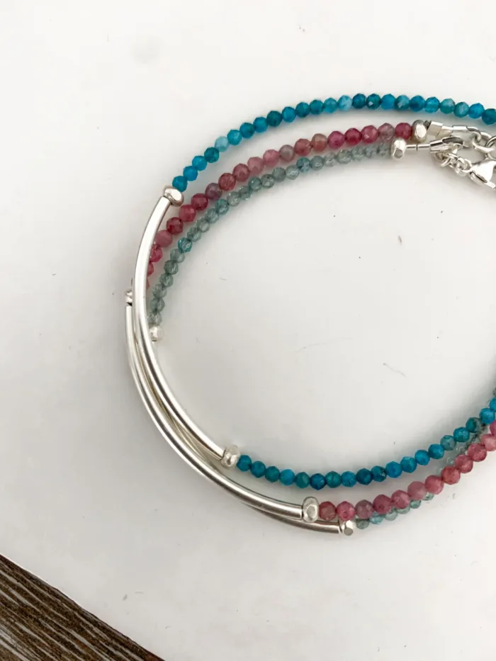 sterling silver curve bar bracelet with small faceted gemstones. wear solo or stacked up.