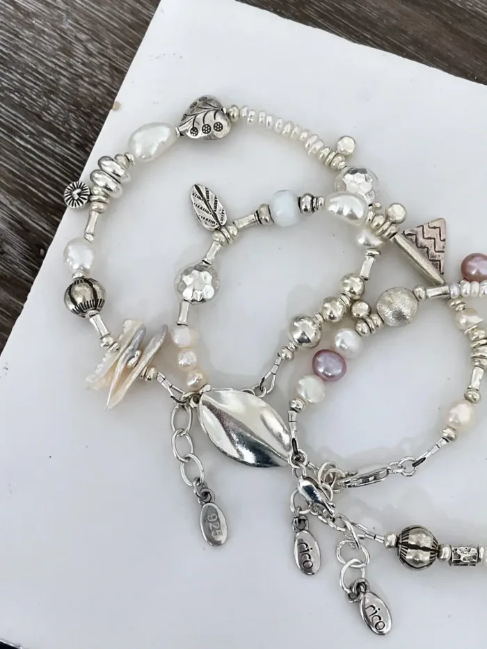 freshwater pearl silver bracelet with lots of charms.