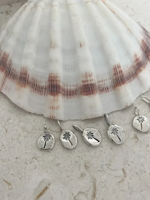handmade sterling silver necklace with hand stamped palm tree pendant for a beach inspired everyday minimal style necklace.