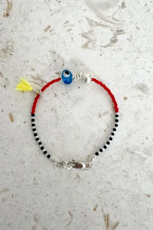Handmade pure silver bracelet featuring colourful seed beads and an evil eye – a great minimal bracelet to add to your bracelet stack