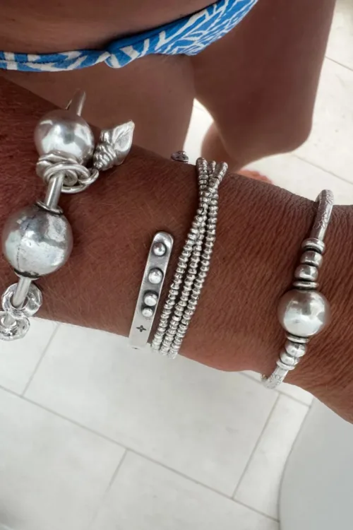 sterling silver bangle with pure silver ball beads and shell charm tassel. Handmade and ocean inspired. ocean safe and perfect to wear everyday