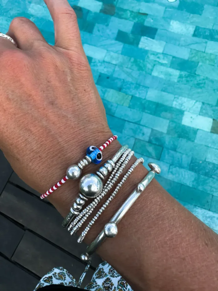 Handmade pure silver bracelet featuring colourful seed beads and an evil eye – a great minimal bracelet to add to your bracelet stack