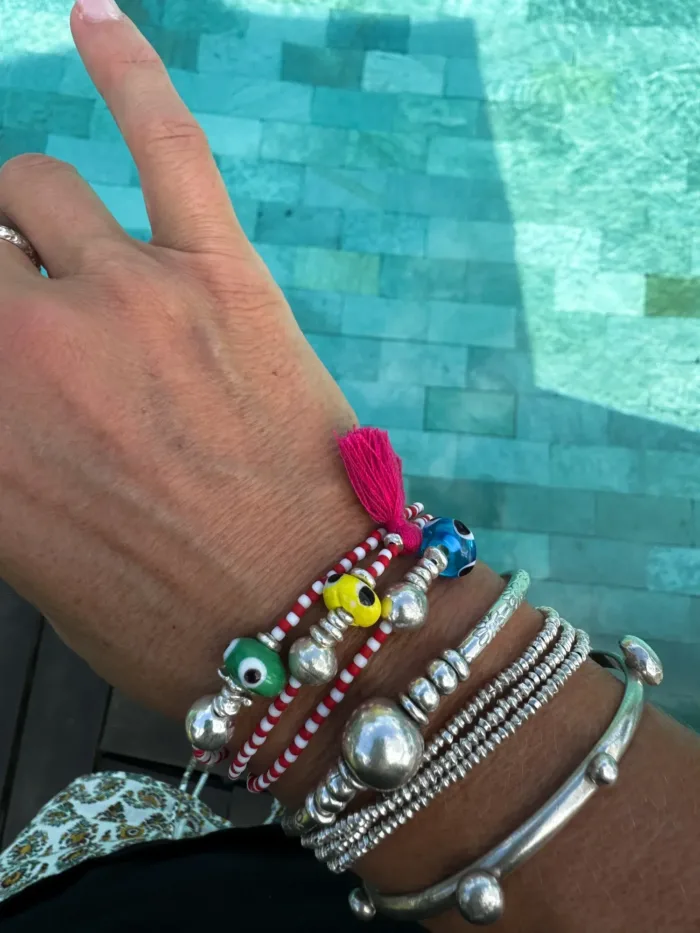 Handmade pure silver bracelet featuring colourful seed beads and an evil eye – a great minimal bracelet to add to your bracelet stack