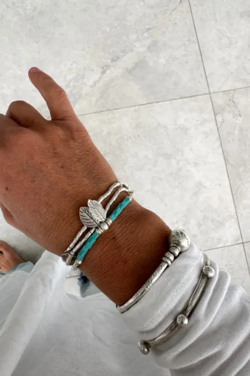 bohemian style silver jewellery. sterling silver wrap bracelet with 2 leaf charms - water safe for everyday wear. styled in bracelet stack