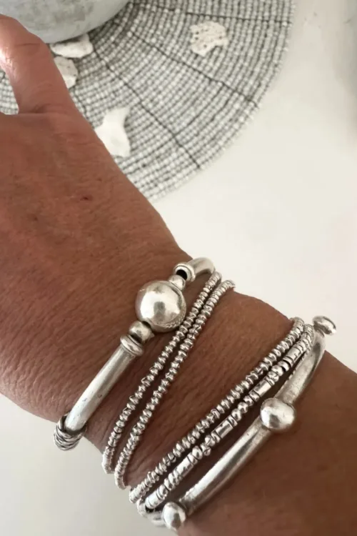 solid pure silver curve bar stretch bracelet. Easy to slip oxn and off. Ocean safe and strong. looks great in a bracelet stack. Knot Bar 2 Moons Silver Bracelet