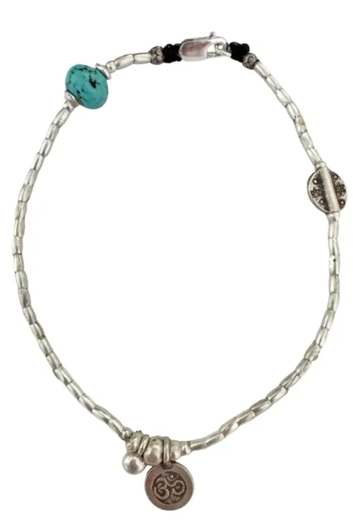 boho luxe pure silver anklet for bohemian style. Featuring a small silver om charm with turquoise hoplite gemstone. Ocean safe. Designed to be worn everyday.