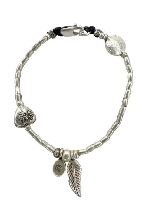 pure silver bracelet boho inspired. feather pendant perfect for everyday wear. ocean safe.