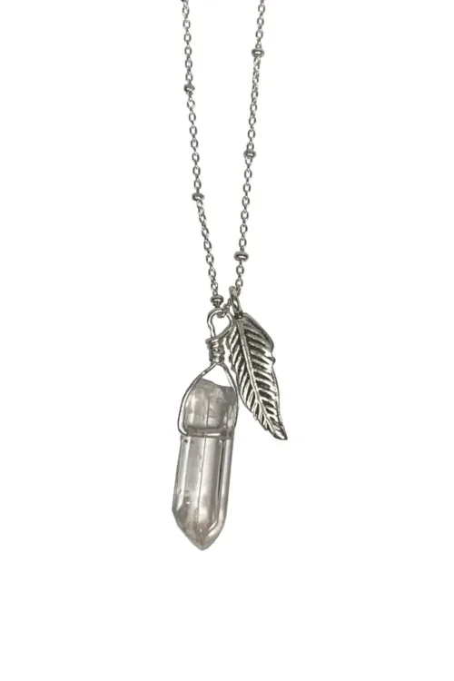 sterling silver necklace with silver feather pendant and crystal quartz pendant. Both floating on a sterling silver chain. Handmade in Sydney Australia. Ocean safe