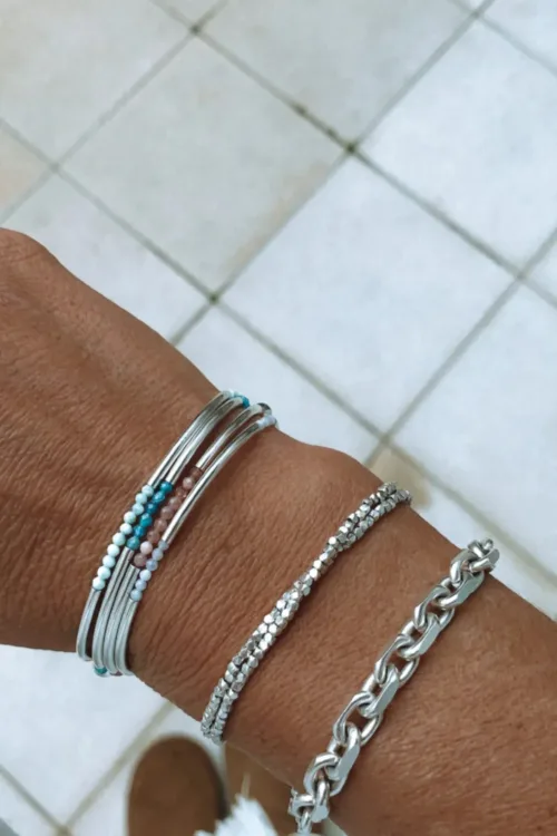 sterling silver curve bar bracelet with small faceted gemstones. wear solo or stacked up.