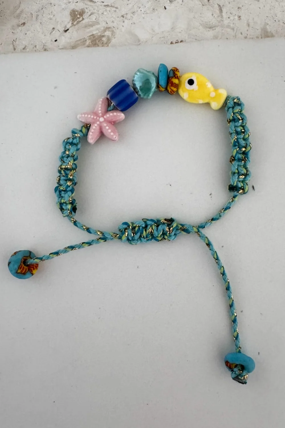 fish macrame bracelet adjustable colourful blue cord. perfect to add colour to a bracelet stack this summer.