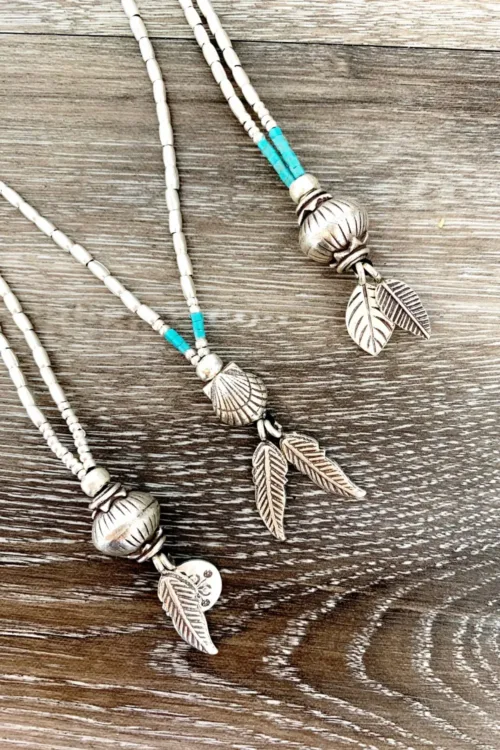 pure silver medium to long necklace with detailed feature ball and charm tassel. Ocean safe handmade jewellery