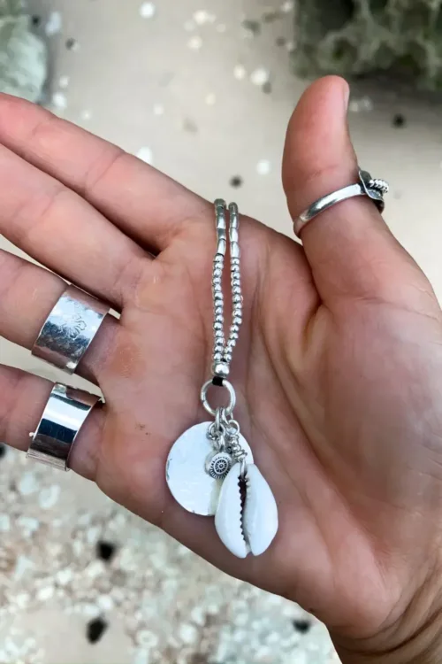 pure silver necklace with hand cut sterling silver round disc pendant and beach inspired cowrie shell pendant. Medium length necklace. beach vibes style. Ocean safe for everyday wear