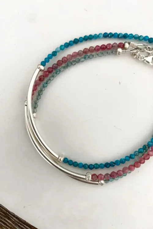 sterling silver curve bar bracelet with small faceted gemstones. wear solo or stacked up.