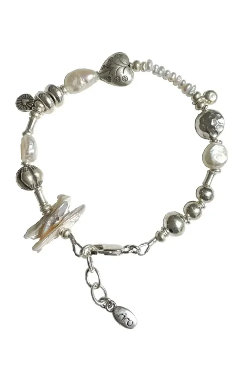 freshwater pearl silver bracelet with lots of charms.