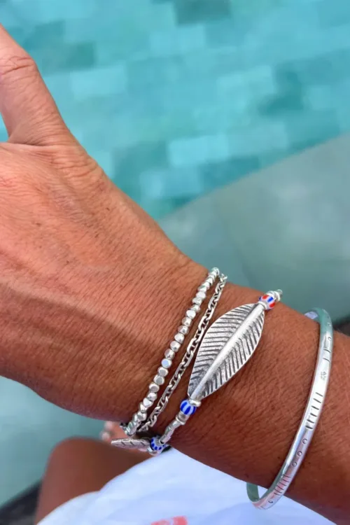 large curve leaf silver bracelet with striped chevron bead. water safe