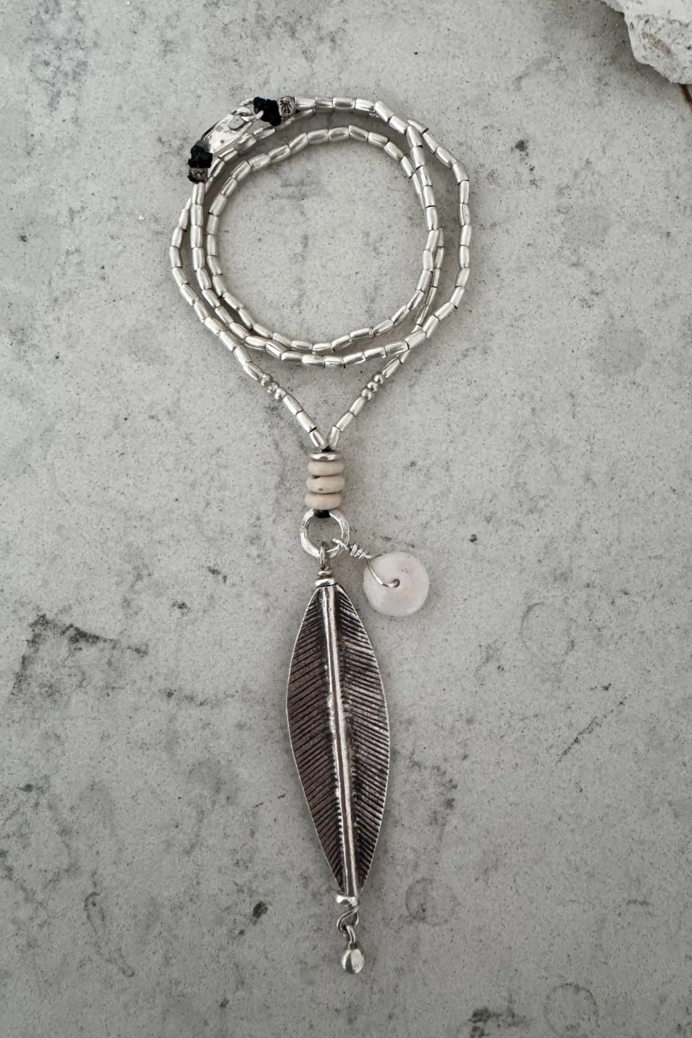 island girl beach inspired silver necklace with natural puri shell and leaf pendant