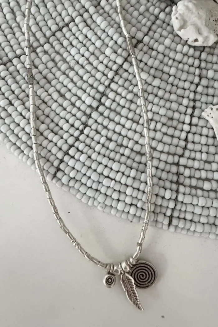 bohemian style silver jewellery. Pure silver wrap bracelet with silver spiral char, feather charm and eye protection charm - for a boho beach chic look- water safe for everyday wear. 3 styles in 1