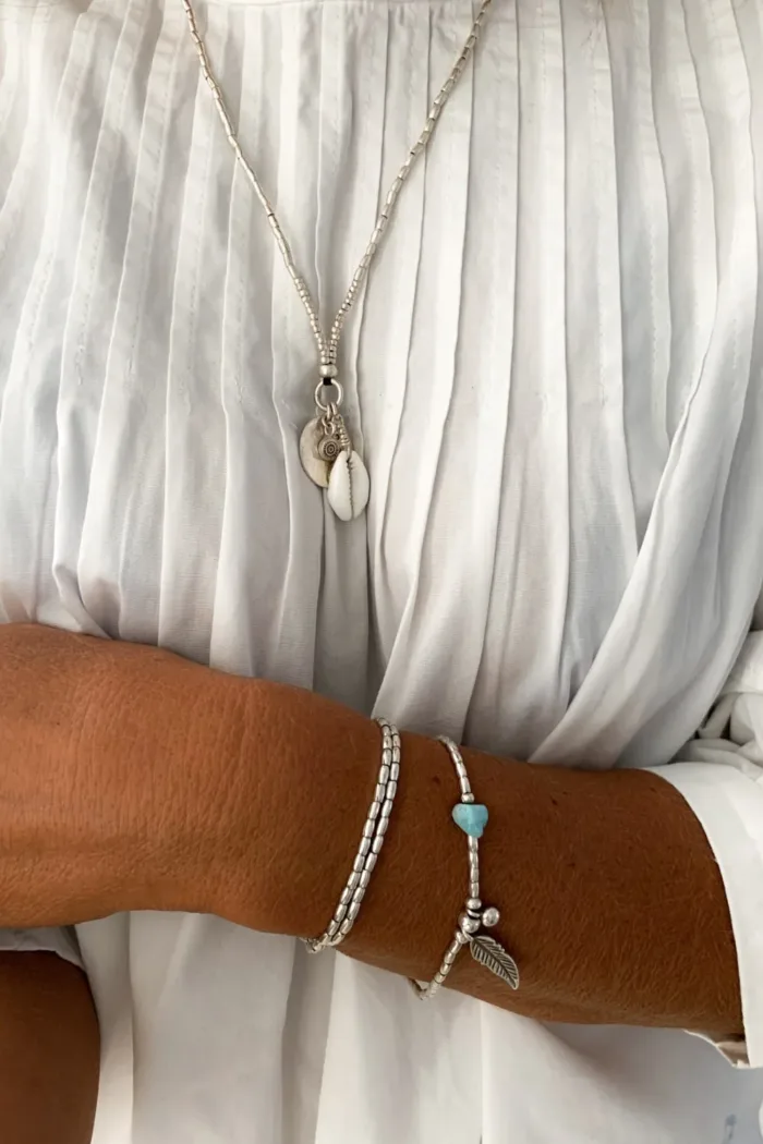 pure silver necklace with hand cut sterling silver round disc pendant and beach inspired cowrie shell pendant. Medium length necklace. beach vibes style. Ocean safe for everyday wear