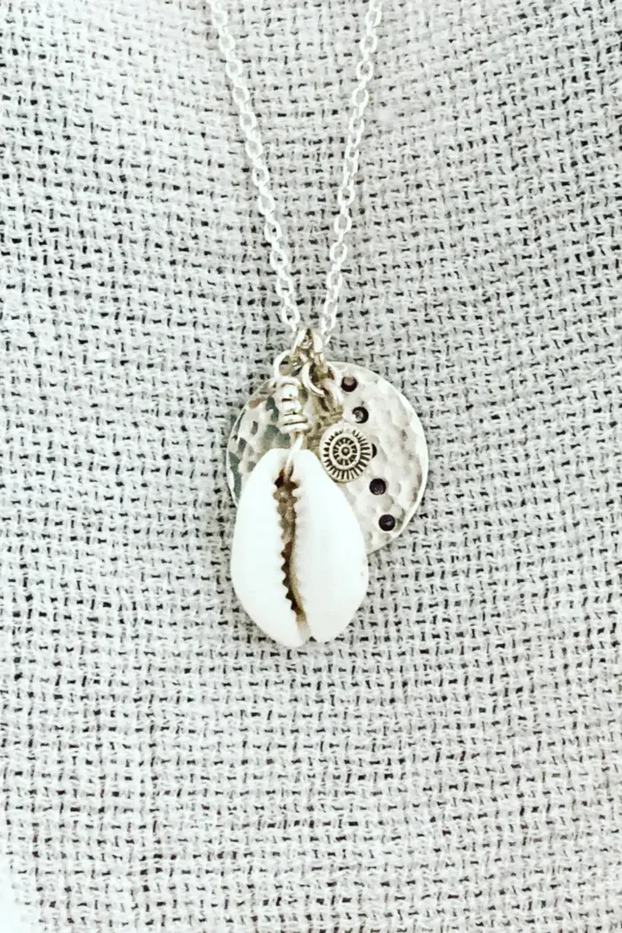 pure silver necklace with hand cut sterling silver round disc pendant and beach inspired cowrie shell pendant. Medium length necklace. beach vibes style. Ocean safe for everyday wear