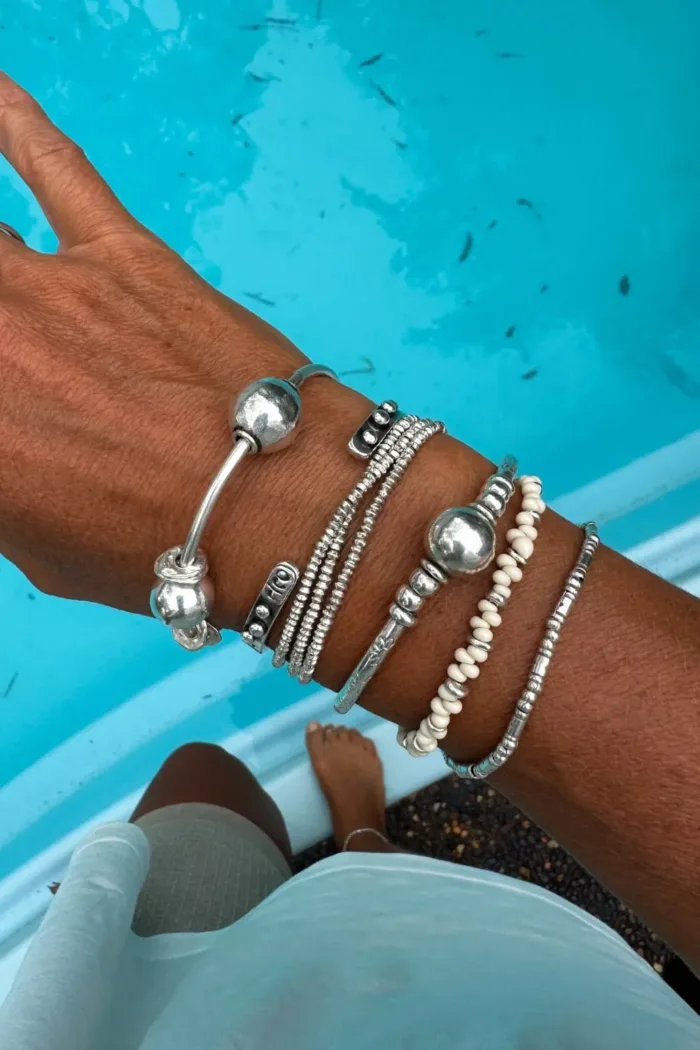 sterling silver bangle with pure silver ball beads and shell charm tassel. Handmade and ocean inspired. ocean safe and perfect to wear everyday