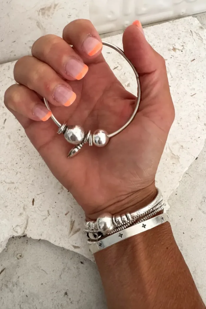 sterling silver bangle with pure silver ball beads and shell charm tassel. Handmade and ocean inspired. ocean safe and perfect to wear everyday