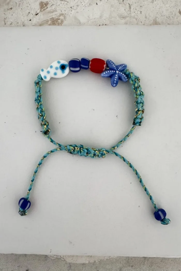 fish macrame bracelet adjustable colourful blue cord. perfect to add colour to a bracelet stack this summer.