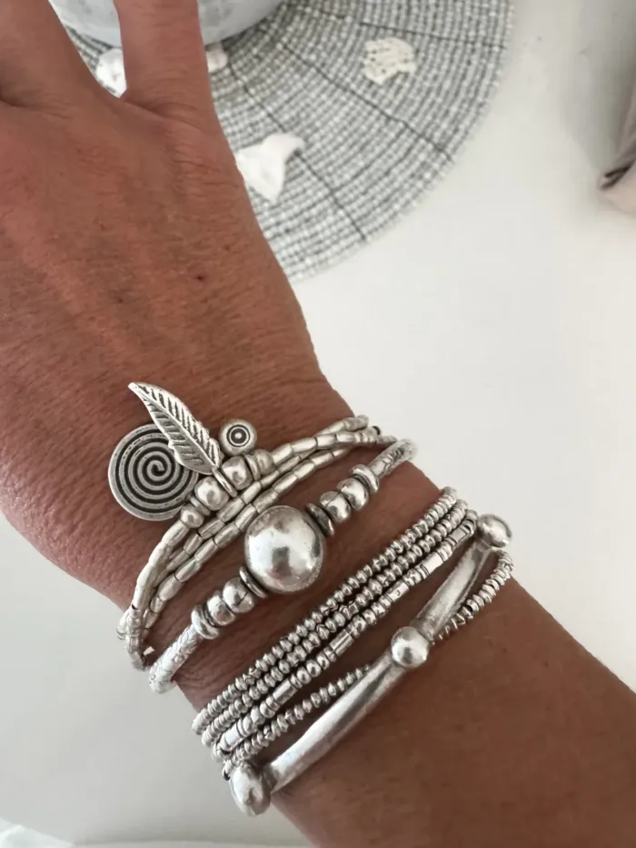 bohemian style silver jewellery. Pure silver wrap bracelet with silver spiral char, feather charm and eye protection charm - for a boho beach chic look- water safe for everyday wear. 3 styles in 1