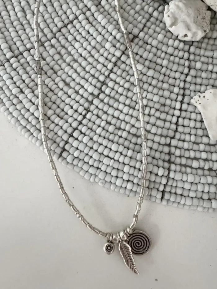 bohemian style silver jewellery. Pure silver wrap bracelet with silver spiral char, feather charm and eye protection charm - for a boho beach chic look- water safe for everyday wear. 3 styles in 1