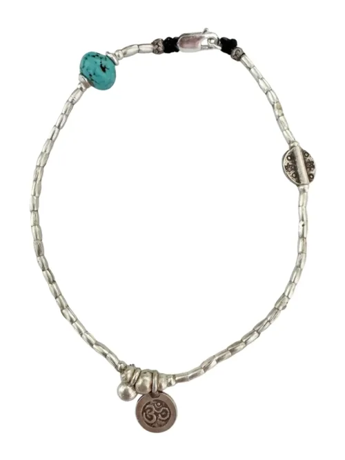 boho luxe pure silver anklet for bohemian style. Featuring a small silver om charm with turquoise hoplite gemstone. Ocean safe. Designed to be worn everyday.