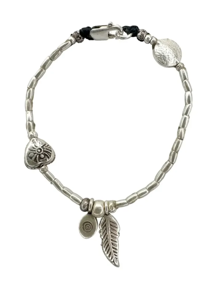 pure silver bracelet boho inspired. feather pendant perfect for everyday wear. ocean safe.