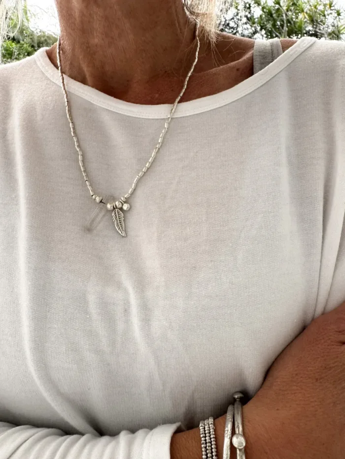 bohemian style silver jewellery. sterling silver necklace with crystal quartz and feather charm - water safe for everyday wear. 3 styles in 1