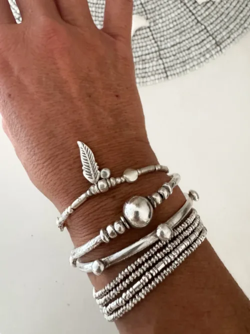 pure silver bracelet boho inspired. feather pendant perfect for everyday wear. ocean safe.