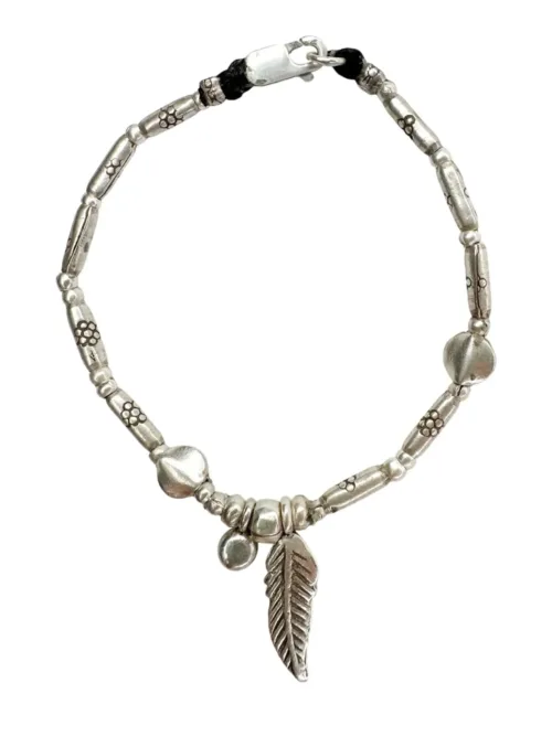 pure silver bracelet boho inspired. feather pendant perfect for everyday wear. ocean safe.