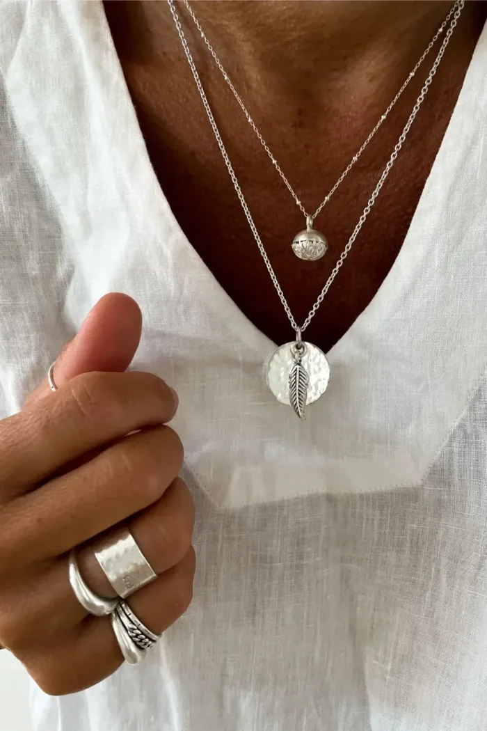 sterling silver disc pendant necklace on sterling silver chain with silver feather pendant handmade ocean safe-jewellery. Sunrise Silver Necklace