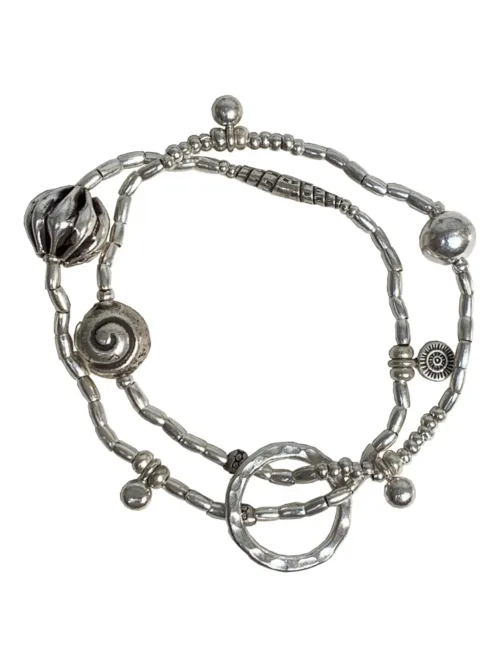 2 strand stitch elastic bracelet. pure silver beach inspired bracelet with silver shells. water safe for everyday wear.