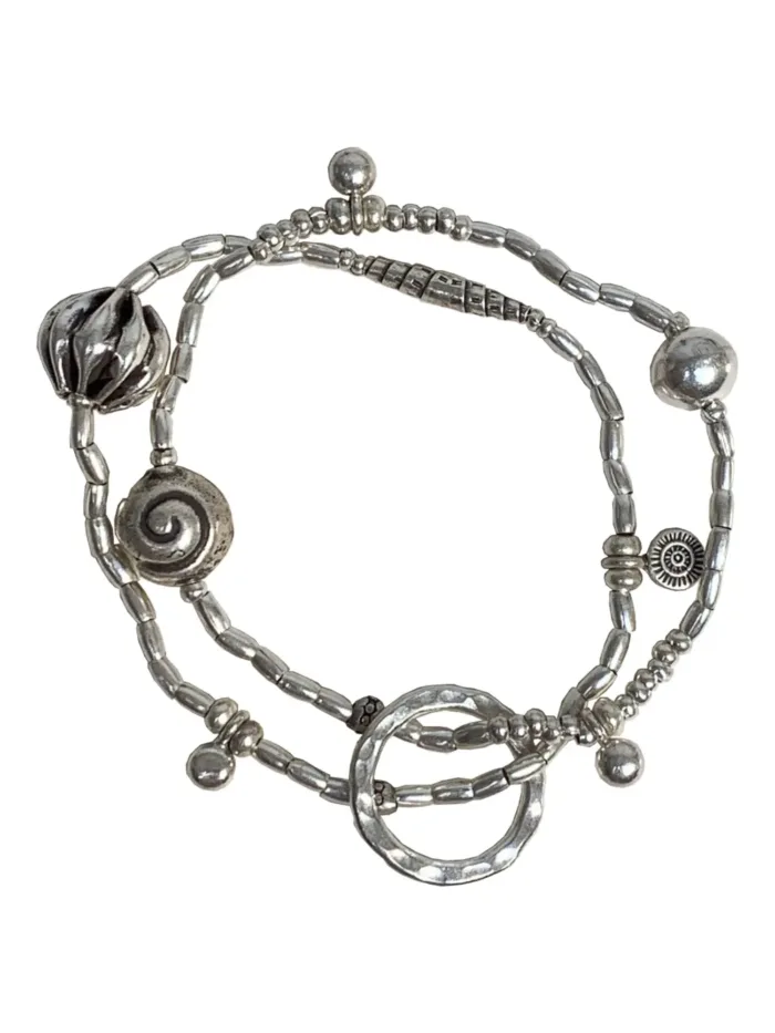 2 strand stitch elastic bracelet. pure silver beach inspired bracelet with silver shells. water safe for everyday wear.