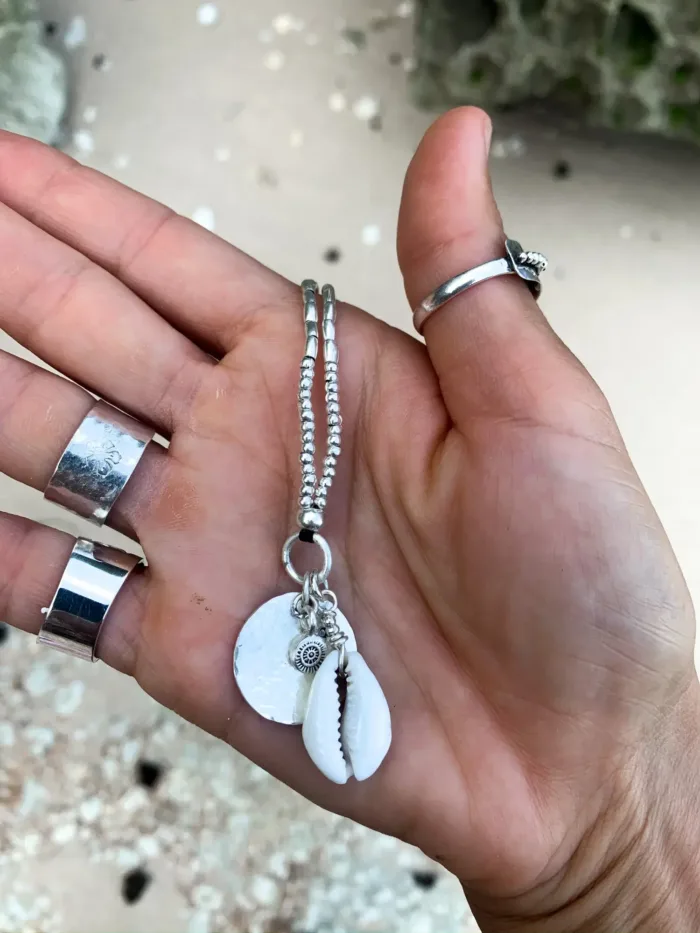 pure silver necklace with hand cut sterling silver round disc pendant and beach inspired cowrie shell pendant. Medium length necklace. beach vibes style. Ocean safe for everyday wear