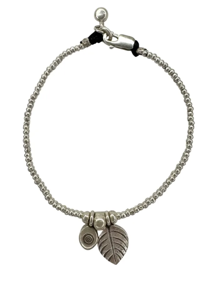pure silver bracelet with leaf and evil eye pendant. tug proof - perfect for active mums. ocean safe