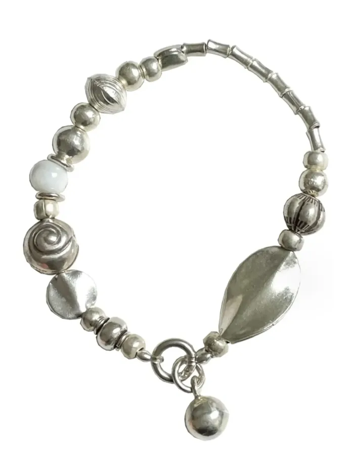 pure silver strong stretch elastic bracelet with white lamp work beads. Easy to slip on and off. Water safe