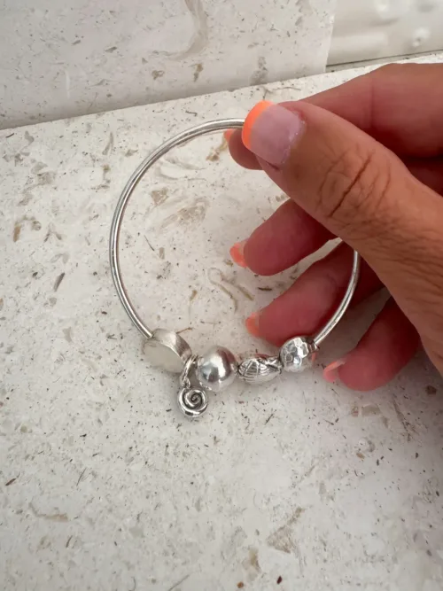 sterling silver bangle with pure silver ball beads and shell charm tassel. Handmade and ocean inspired. ocean safe and perfect to wear everyday