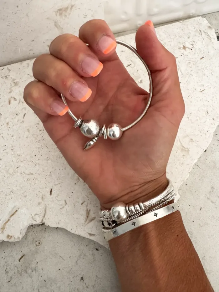 sterling silver bangle with pure silver ball beads and shell charm tassel. Handmade and ocean inspired. ocean safe and perfect to wear everyday