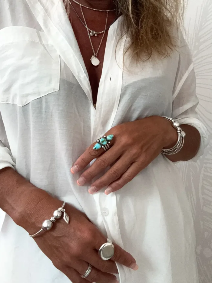 sterling silver bangle with pure silver ball beads and shell charm tassel. Handmade and ocean inspired. ocean safe and perfect to wear everyday