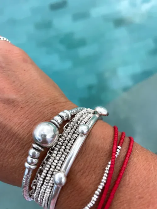 handmade sterling silver bangle with recycled silver blobs. styled in a resort wear style bracelet stack - ocean safe jewellery