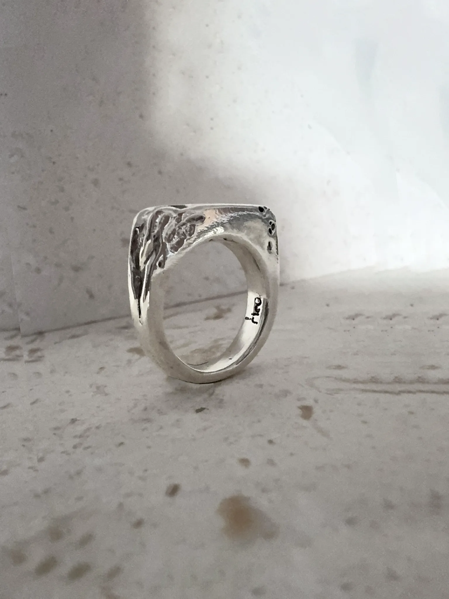 silver signet ring with eroded edge. handmade ring
