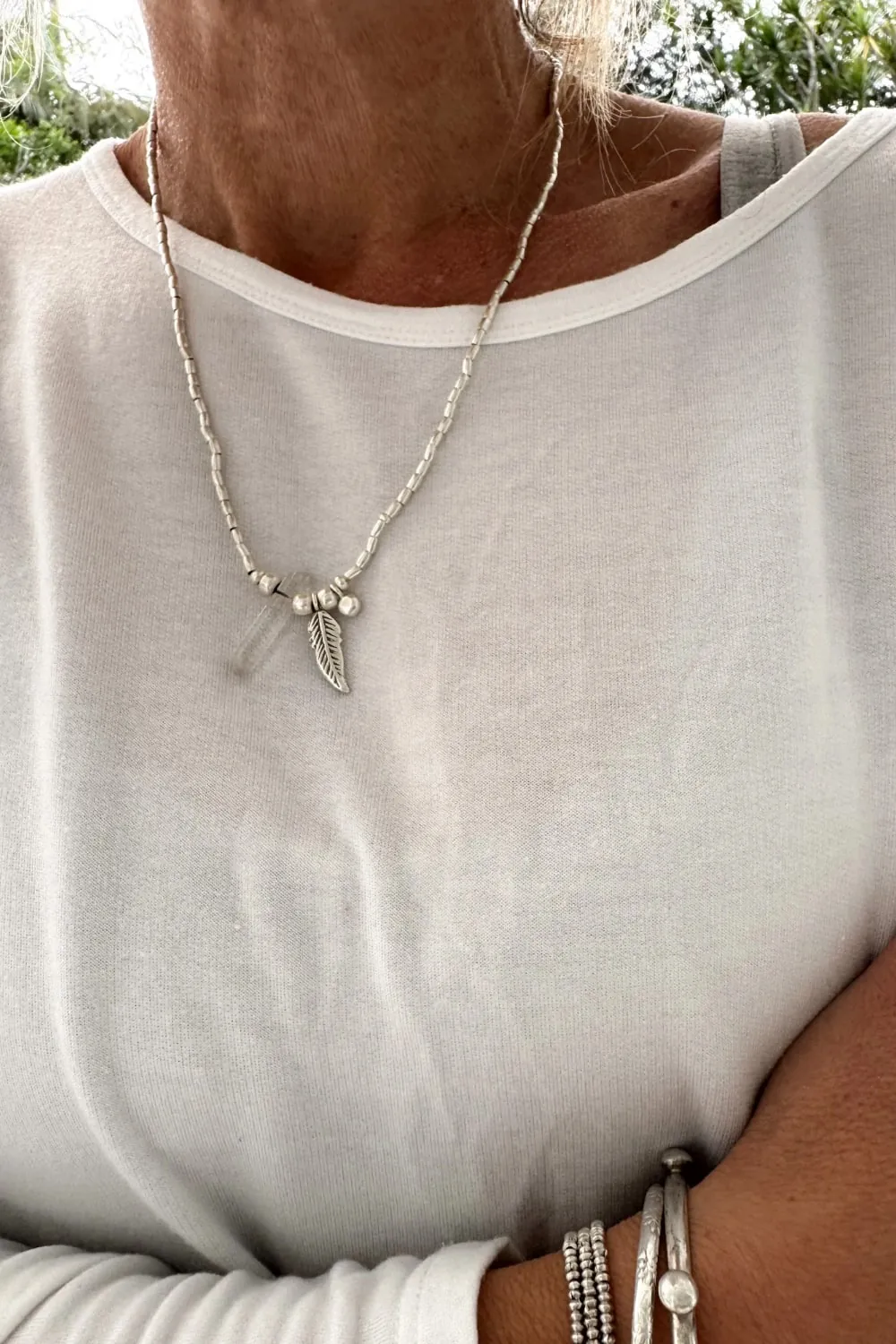 bohemian style silver jewellery. sterling silver wrap bracelet with crystal quartz and feather charm - water safe for everyday wear. 3 styles in 1