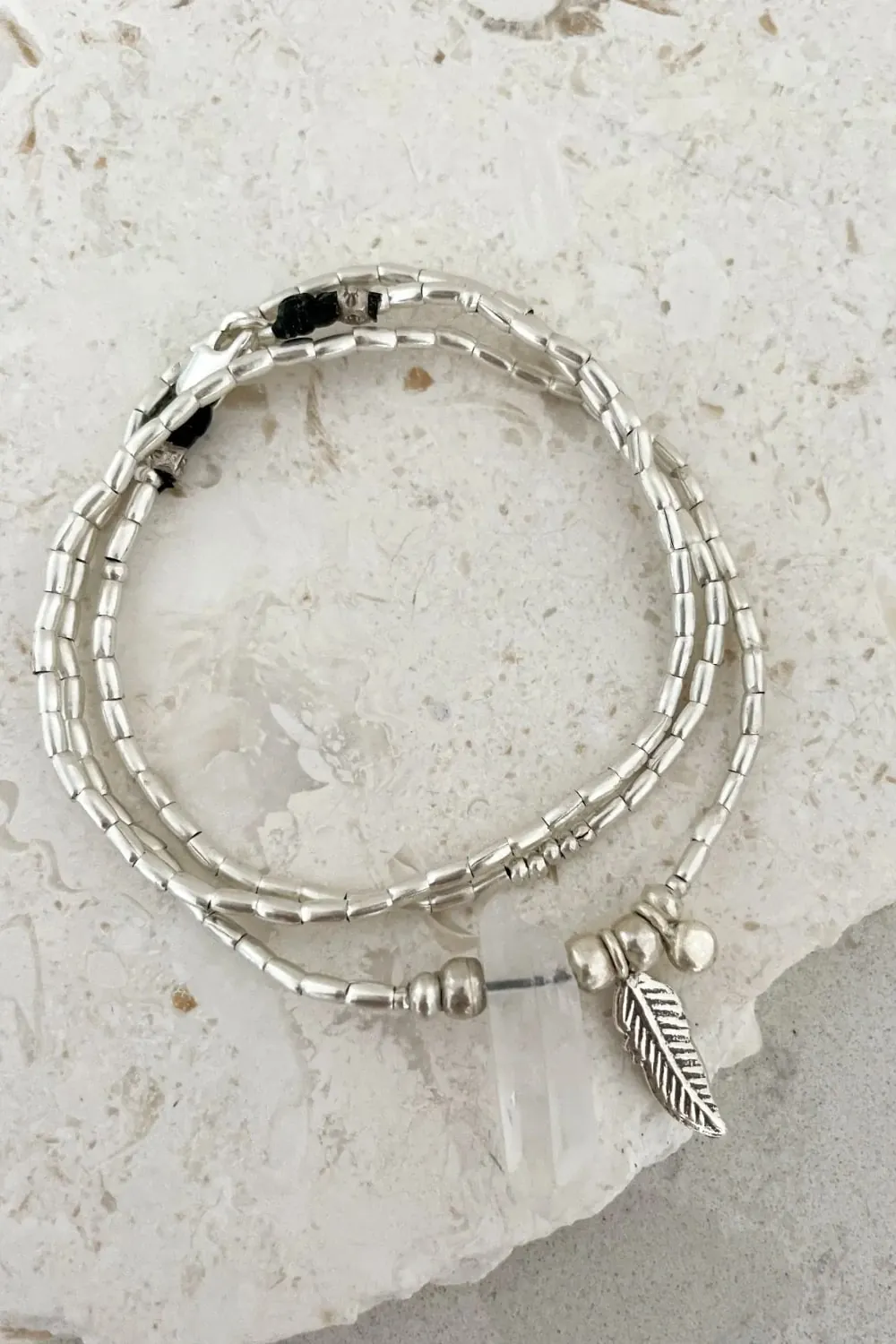 bohemian style silver jewellery. sterling silver wrap bracelet with crystal quartz and feather charm - water safe for everyday wear. 3 styles in 1