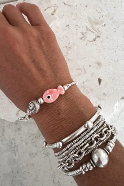 minimal silver bracelet with ceramic fish handmade ocean safe perfect styled in a bracelet stack